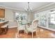 Charming dining room featuring a glass table, chandelier, and access to the screened porch at 4607 Carmel Vista Ln, Charlotte, NC 28226
