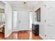 Welcoming foyer with hardwood floors, white door, sidelights, and decorative console table at 4607 Carmel Vista Ln, Charlotte, NC 28226
