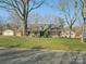 Charming single-story home with a brick facade, mature trees, well-manicured lawn, and a welcoming front porch at 4631 Dawnridge Dr, Charlotte, NC 28226