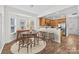 Bright dining area with round table, modern chairs, and breakfast bar adjacent to the kitchen at 471 Doughton Ln, Charlotte, NC 28217