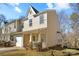Charming townhome featuring a covered porch, one car garage and neutral-toned siding at 471 Doughton Ln, Charlotte, NC 28217