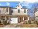 Charming townhome featuring a covered porch, one car garage and neutral-toned siding at 471 Doughton Ln, Charlotte, NC 28217