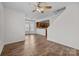 Open-concept living room with wood floors and bright windows flowing into kitchen at 471 Doughton Ln, Charlotte, NC 28217