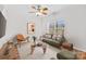 Cozy living room boasts neutral tones, a ceiling fan, and a large window for natural light at 471 Doughton Ln, Charlotte, NC 28217