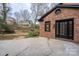 Backyard patio area featuring stylish doors and classic brick at 48 Washington Se Ln, Concord, NC 28025