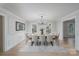 Formal dining room featuring wainscoting, elegant chandelier, and an ornate ceiling medallion at 48 Washington Se Ln, Concord, NC 28025