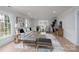 Spacious living room featuring wainscoting, neutral tones, and plenty of natural light at 48 Washington Se Ln, Concord, NC 28025