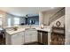 Kitchen bar overlooking living area featuring stainless steel dishwasher and quartz countertop at 5212 Spanish Ivy Ln, Indian Land, SC 29707