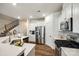 Bright kitchen with stainless steel appliances, gas range, and quartz countertops at 5212 Spanish Ivy Ln, Indian Land, SC 29707