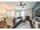 Open-concept living room featuring a gray sectional and hardwood floors at 5212 Spanish Ivy Ln, Indian Land, SC 29707