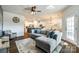 Open-concept living room with hardwood floors, a large gray sectional, and modern decor at 5212 Spanish Ivy Ln, Indian Land, SC 29707