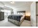 Spacious main bedroom with a large bed, tray ceiling, and neutral-colored walls at 5212 Spanish Ivy Ln, Indian Land, SC 29707