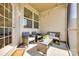 Covered patio with wicker furniture, string lights, and views of the backyard at 5212 Spanish Ivy Ln, Indian Land, SC 29707