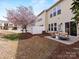 A well-maintained backyard with a patio area, a privacy fence, and a lovely flowering tree at 6449 Silver Star Ln, Charlotte, NC 28210