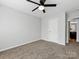 Bright bedroom with ceiling fan, carpeted floor, and an adjoining doorway to the rest of the home at 6449 Silver Star Ln, Charlotte, NC 28210
