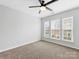 A bright bedroom featuring a ceiling fan and three windows that provide lots of natural light at 6449 Silver Star Ln, Charlotte, NC 28210