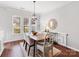 Bright dining room features hardwood floors, modern lighting, and large windows at 6449 Silver Star Ln, Charlotte, NC 28210