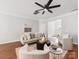 Comfortable living room featuring hardwood floors, a ceiling fan, and neutral decor at 6449 Silver Star Ln, Charlotte, NC 28210