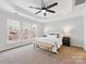 Spacious main bedroom with large windows and ceiling fan at 6449 Silver Star Ln, Charlotte, NC 28210
