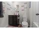 Well-lit bathroom featuring a vanity, toilet, and stylish decor at 668 Pointe Andrews Sw Dr # 93, Concord, NC 28025