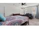 Bright bedroom with a ceiling fan, cozy seating area, and two large windows for ample natural light at 668 Pointe Andrews Sw Dr # 93, Concord, NC 28025