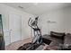 Bedroom with a black leather couch and workout equipment at 668 Pointe Andrews Sw Dr # 93, Concord, NC 28025