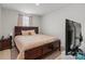 Bedroom featuring a queen bed, side table and a large TV at 668 Pointe Andrews Sw Dr # 93, Concord, NC 28025