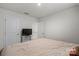 Bedroom with bed, tv, and doors to closet space at 668 Pointe Andrews Sw Dr # 93, Concord, NC 28025