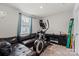 Bedroom with black leather couch and elliptical machine at 668 Pointe Andrews Sw Dr # 93, Concord, NC 28025