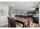 Open floor plan with dining area flowing into living and kitchen spaces, hardwood floors at 668 Pointe Andrews Sw Dr # 93, Concord, NC 28025