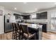 Modern kitchen with stainless steel appliances, granite countertops, and a large center island with bar stool seating at 668 Pointe Andrews Sw Dr # 93, Concord, NC 28025