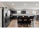 Modern kitchen with stainless steel appliances, dark cabinetry, and a center island with seating at 668 Pointe Andrews Sw Dr # 93, Concord, NC 28025