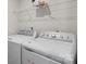 Convenient laundry room with washer, dryer, and shelving for optimal organization at 668 Pointe Andrews Sw Dr # 93, Concord, NC 28025