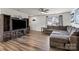 Inviting living room featuring hardwood floors, a cozy sofa, and a built in fireplace and tv stand at 668 Pointe Andrews Sw Dr # 93, Concord, NC 28025