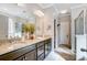 Bathroom featuring double vanity with granite countertops and wood cabinets at 7035 Walnut Branch Ln, Charlotte, NC 28277