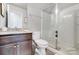 Modern bathroom featuring a glass-enclosed shower, vanity with granite countertop and neutral wall paint at 7035 Walnut Branch Ln, Charlotte, NC 28277