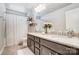 Bathroom features a double vanity with granite countertop and a shower with decorative curtain at 7035 Walnut Branch Ln, Charlotte, NC 28277