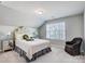 This bedroom has a floral headboard and a large window at 7035 Walnut Branch Ln, Charlotte, NC 28277