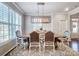 Bright dining area featuring a rustic wooden table with seating for six, stylish chandelier and natural light at 7035 Walnut Branch Ln, Charlotte, NC 28277