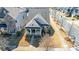 Aerial view of a well-maintained home with a charming front porch and landscaped front yard at 7035 Walnut Branch Ln, Charlotte, NC 28277