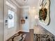 Welcoming foyer features a decorative mirror and console table with a beautiful wreath and coat rack at 7035 Walnut Branch Ln, Charlotte, NC 28277