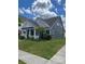 Charming single-Gathering home featuring a covered front porch, well-maintained lawn, and beautiful landscaping at 7035 Walnut Branch Ln, Charlotte, NC 28277