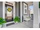 Inviting front porch features a decorated front door, a cozy bench, and fresh green plants at 7035 Walnut Branch Ln, Charlotte, NC 28277