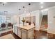Open kitchen with oversized island, ideal for entertaining and casual dining, and stairway to the right at 7035 Walnut Branch Ln, Charlotte, NC 28277