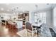 Open-concept kitchen and dining area featuring a marble island, stainless steel appliances, and a dining table at 7035 Walnut Branch Ln, Charlotte, NC 28277