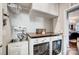 Bright laundry room with modern washer, dryer, and overhead cabinets at 7035 Walnut Branch Ln, Charlotte, NC 28277