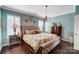 Inviting main bedroom with hardwood floors, plantation shutters, and elegant furnishings at 7035 Walnut Branch Ln, Charlotte, NC 28277
