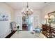 Bright office showcasing glass doors, chandelier lighting, and a view into the kitchen at 7035 Walnut Branch Ln, Charlotte, NC 28277