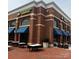 Exterior of a Mexican restaurant featuring a brick facade, blue awnings, and outdoor seating at 7035 Walnut Branch Ln, Charlotte, NC 28277