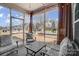 Relaxing screened-in porch with outdoor furniture, curtains, and a view of the neighborhood at 7035 Walnut Branch Ln, Charlotte, NC 28277
